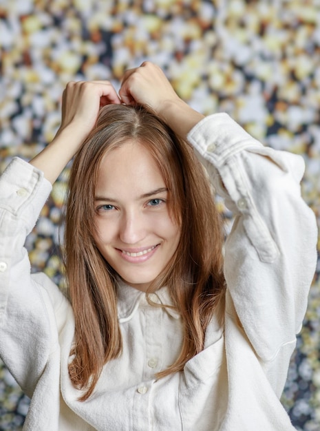 Beautiful smiling young woman with perfect skin face natural beauty concept isolated on grey studio background