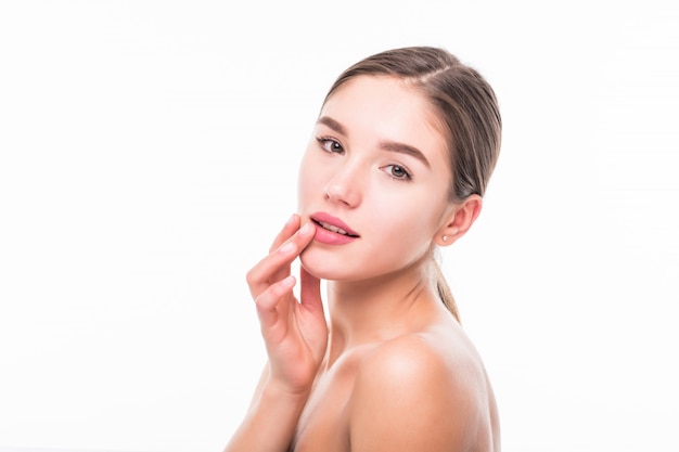 Beautiful spa young woman touching her face isolated on white wall.