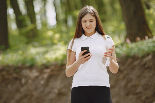 Beautiful sports girl in a summer forest