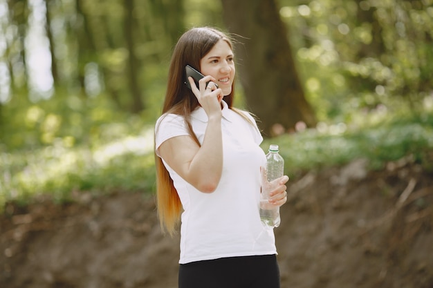 Beautiful sports girl in a summer forest