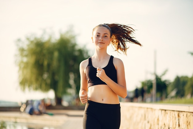 Beautiful sports girl in a summer park