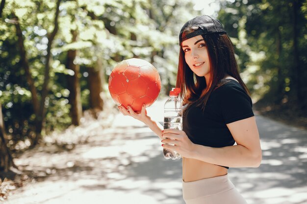 Beautiful sportsgirl in a summer sunny park