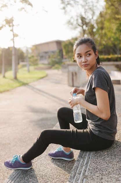 Beautiful sportswoman holding a water bottle