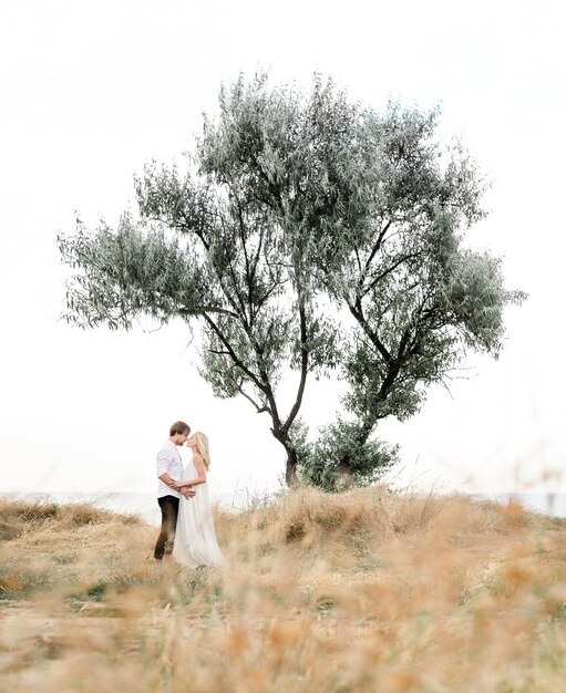 Beautiful stylish couple walking on the coast