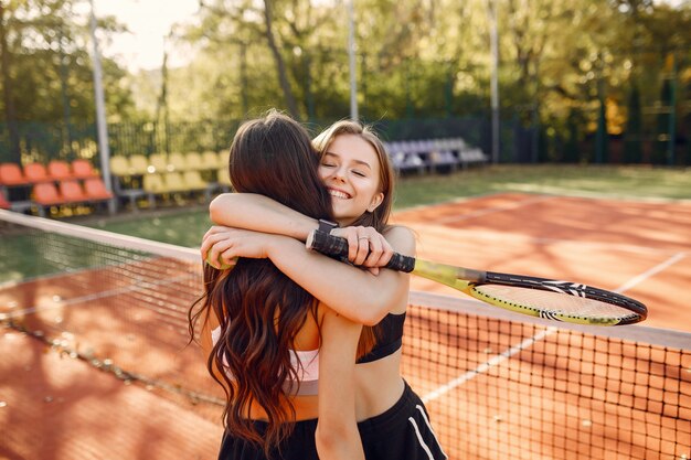 Beautiful and stylish girls on the tennis court