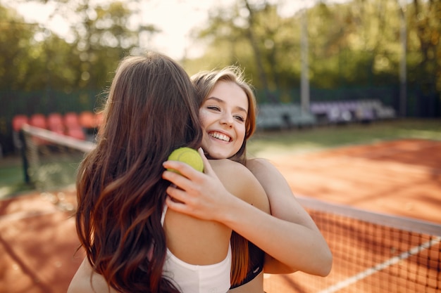 Beautiful and stylish girls on the tennis court