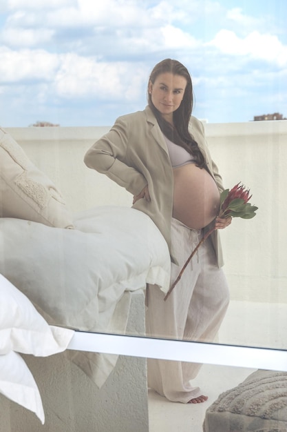 Free Photo beautiful stylish pregnant woman with protea flower pregnancy concept