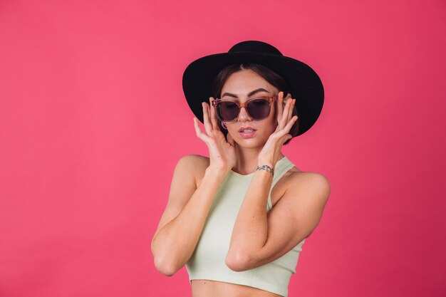 Beautiful stylish woman in hat and sunglasses posing