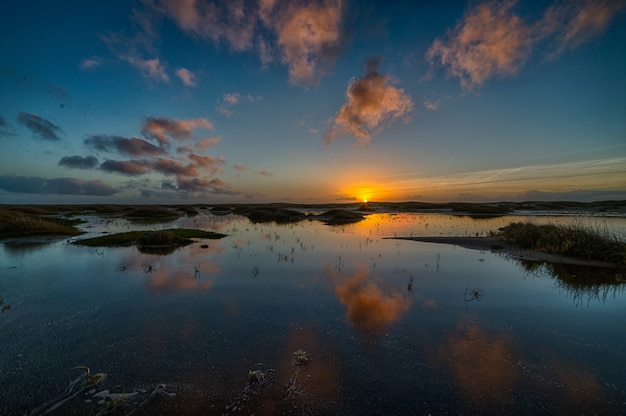 Beautiful sunset reflecting in the sea creating the perfect scenery for evening walks