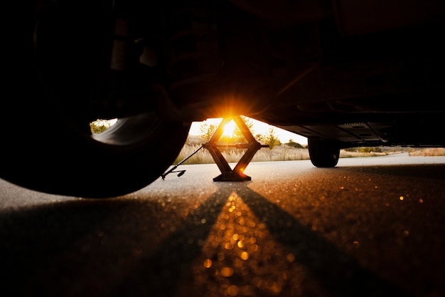 Free Photo beautiful sunset through a lifted car