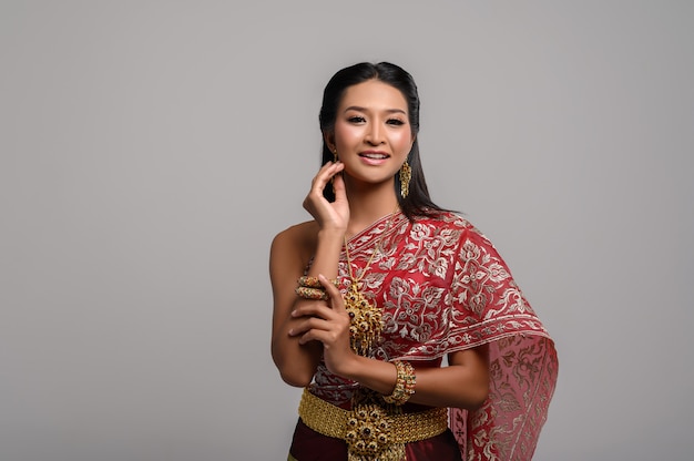 Beautiful Thai woman wearing a Thai dress and a happy smile.