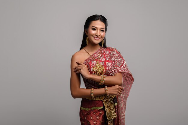 Beautiful Thai woman wearing a Thai dress and a happy smile.