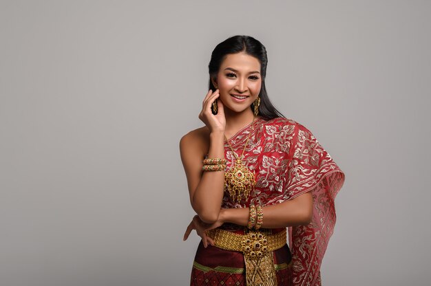 Beautiful Thai woman wearing a Thai dress and a happy smile.