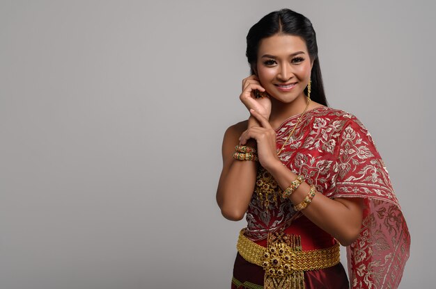 Beautiful Thai woman wearing a Thai dress and a happy smile.