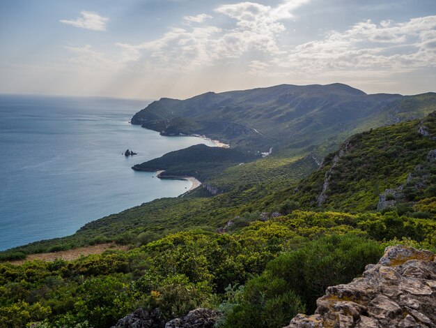 Beautiful top view shot hills covered in forests in Parque Natural da Arrábida in Casal, Portugal