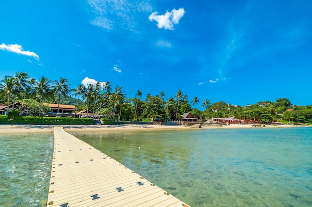 Free Photo beautiful tropical beach sea and sand with coconut palm tree on blue sky and white cloud