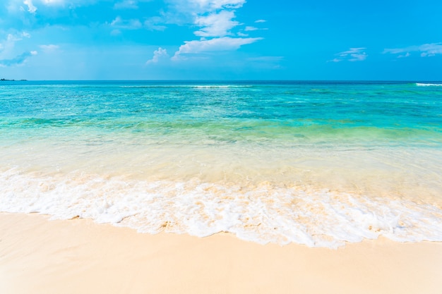 Beautiful tropical empty beach sea ocean with white cloud on blue sky background