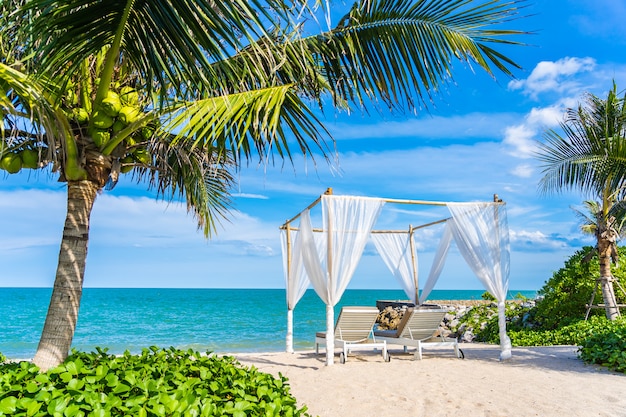 Beautiful umbrella and chair around beach sea ocean with blue sky for travel