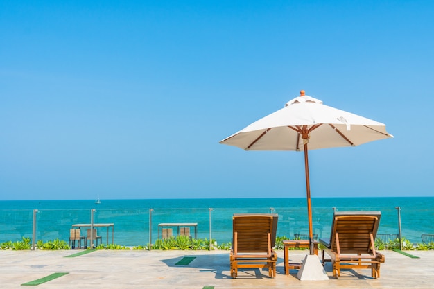 Free photo beautiful umbrella and chair around swimming pool in hotel and resort