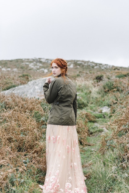 Free Photo beautiful vertical picture of a ginger female with a pure white skin in an attractive light gown