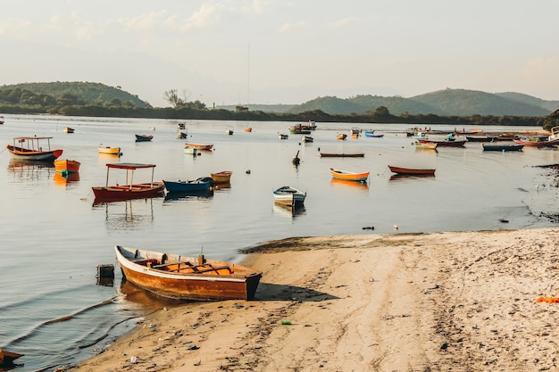 Beautiful view of a bay with fishing boats near a sandy shore