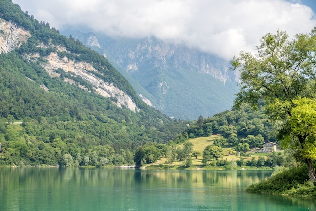 Beautiful view of the calm lake of Tenno, located in Trentino, Italy during daylight