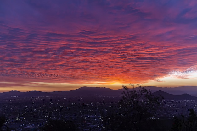 Beautiful view of a city in a valley under the exotic colorful sky