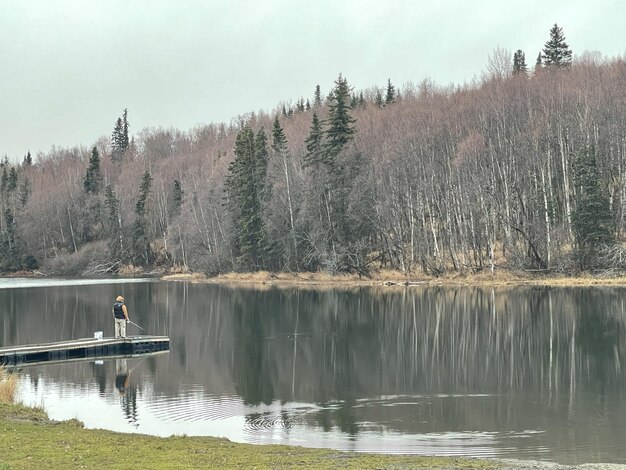 Beautiful view of a fisherman catching a fish from a lake