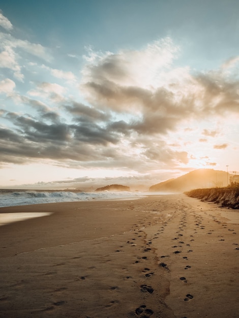 Beautiful view of footprints in the sand during sunset at the beach in Rio de Janeiro