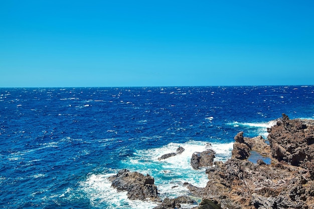 Free Photo beautiful view from the cliff of mountain to the ocean with blue sky and clouds