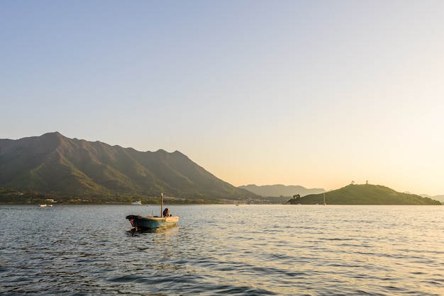 Beautiful view of a motorboat on the calm surface of the sea near the mountains