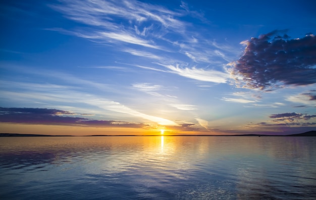 Beautiful view of the sea with the sun shining in a blue sky in the background