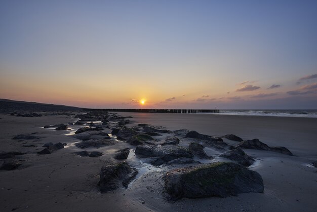 Beautiful view of the sunset with purple clouds over the beach