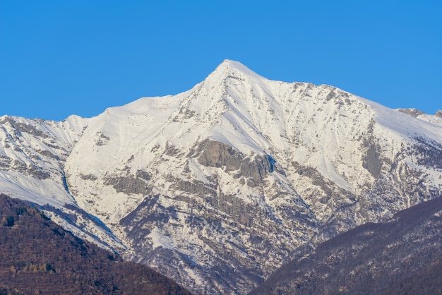 Beautiful view of a tall mountain covered with white snow