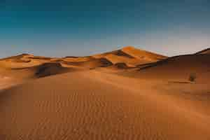 Free photo beautiful view of tranquil desert under the clear sky captured in morocco