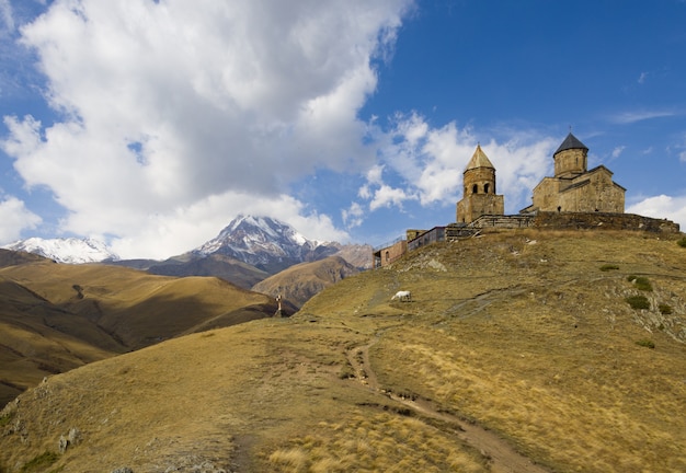 Beautiful view of the Trinity Church of Gergeti captured under the cloudy sky in Georgia