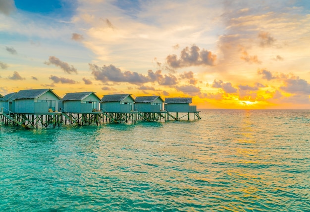 Free Photo beautiful water villas in tropical maldives island at the sunset time