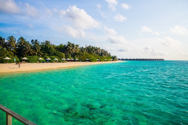 Beautiful wavy ocean hitting the sandy beach in the Maldives Island