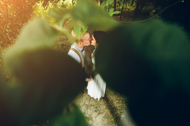 Beautiful wedding couple posing in a forest