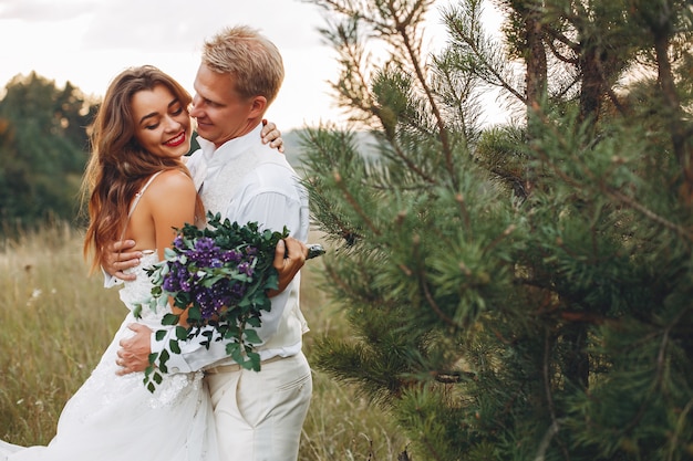 Free photo beautiful wedding couple in a summer field