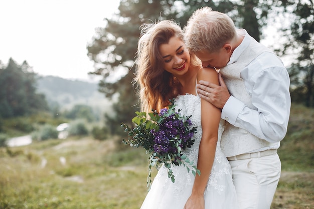 Free photo beautiful wedding couple in a summer field