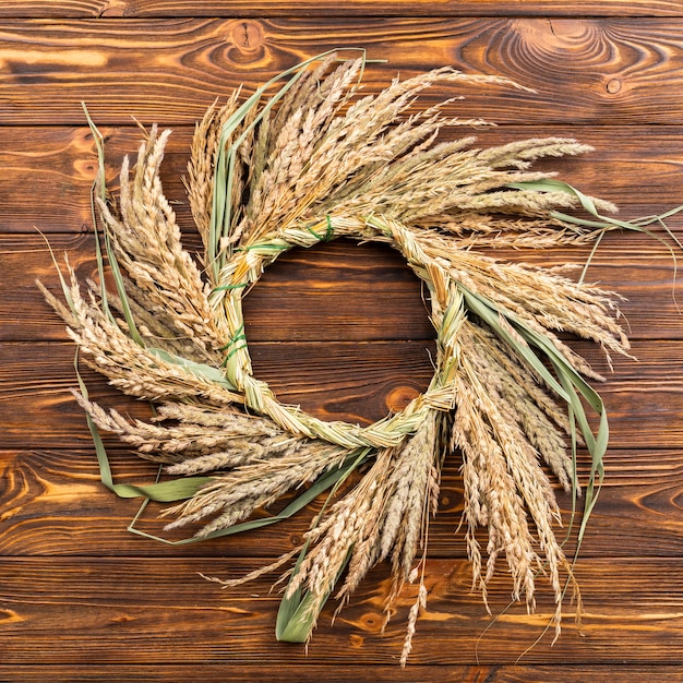 Beautiful wheat frame on wooden background 