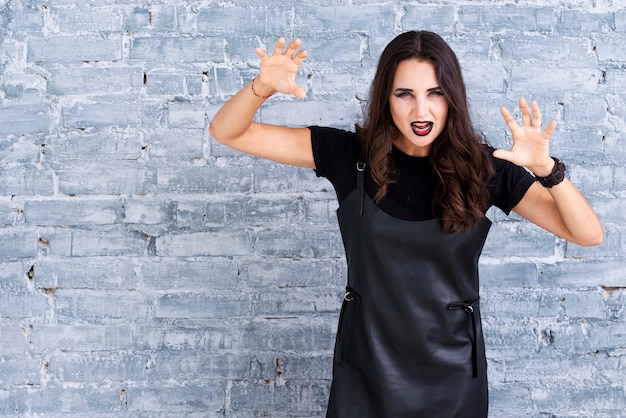 Free photo beautiful woman in black dress for halloween