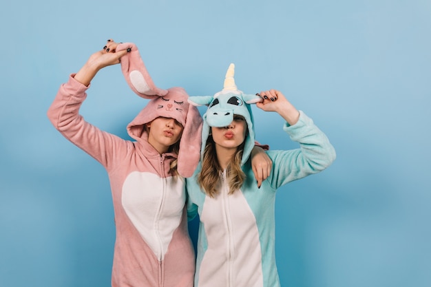 Beautiful woman in bunny kigurumi posing with friend