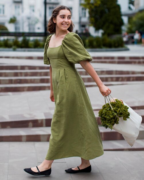 Beautiful woman carrying organic groceries