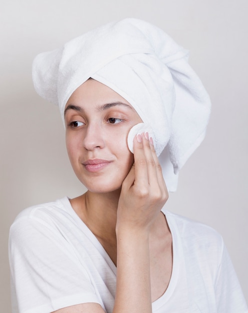 Beautiful woman cleaning face process