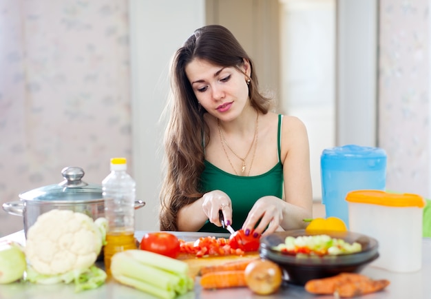 beautiful woman cooking vegetarian salad