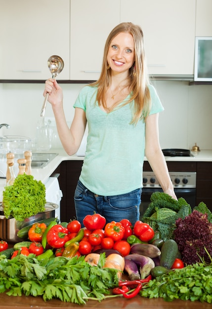 beautiful woman cooking with  ladle from vegetables