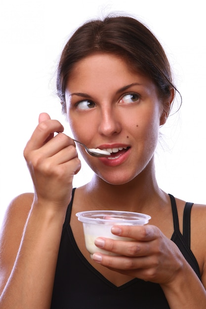 Beautiful woman eating dessert jogur