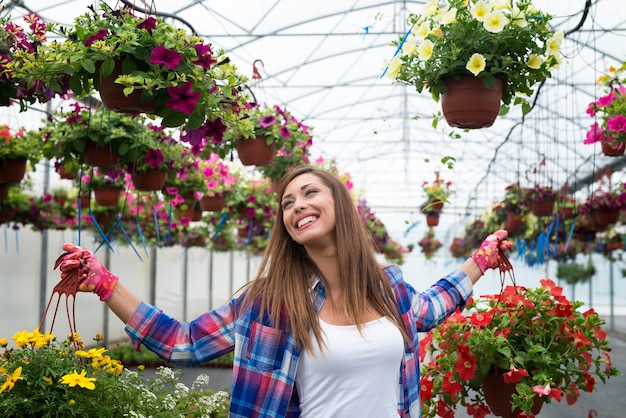 Beautiful woman enjoys working with flowers